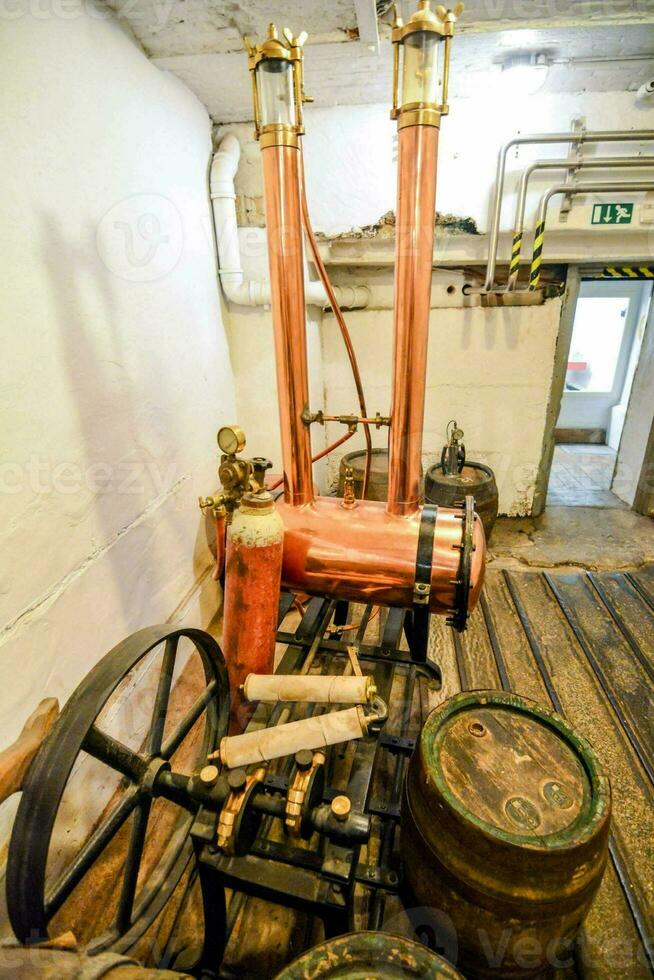 a steam engine in a room with barrels photo