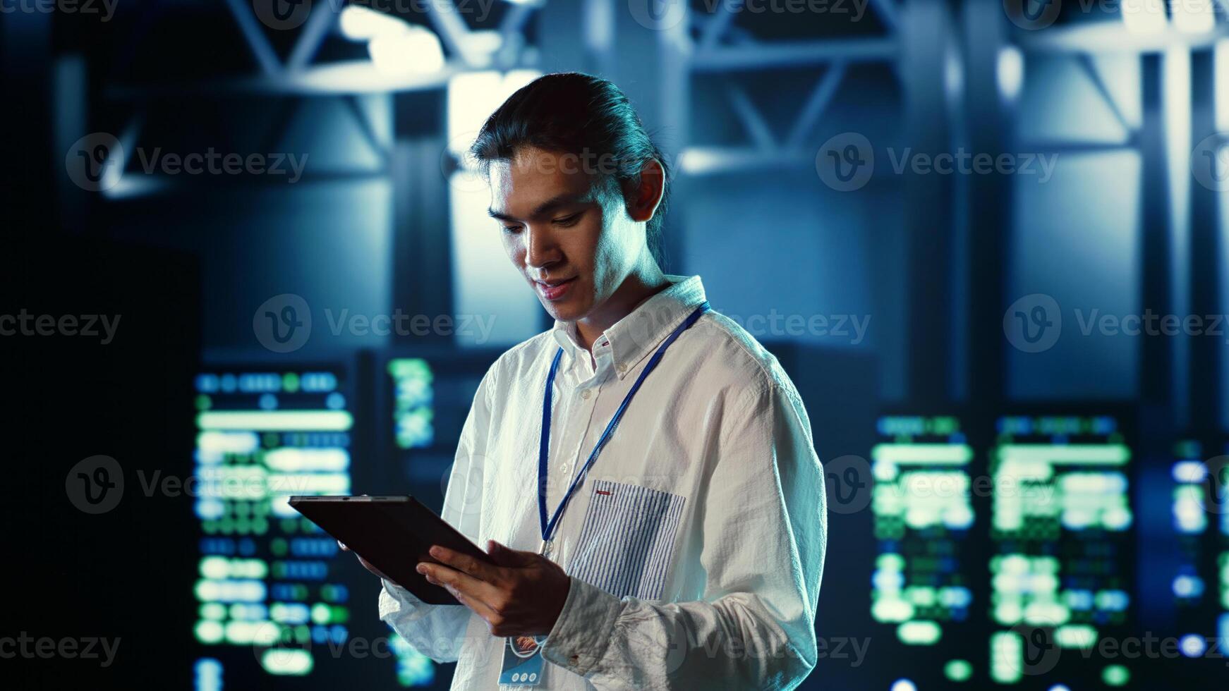 Proactive employee walking through data center electronics providing processing resources for different workloads. Organized engineer evaluating server rigs tasked with solving complex operations photo