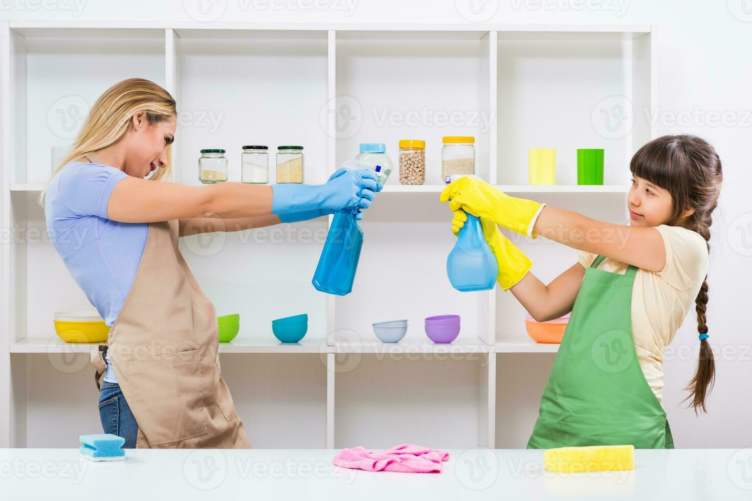 Happy mother and her daughter enjoy cleaning and having fun together photo