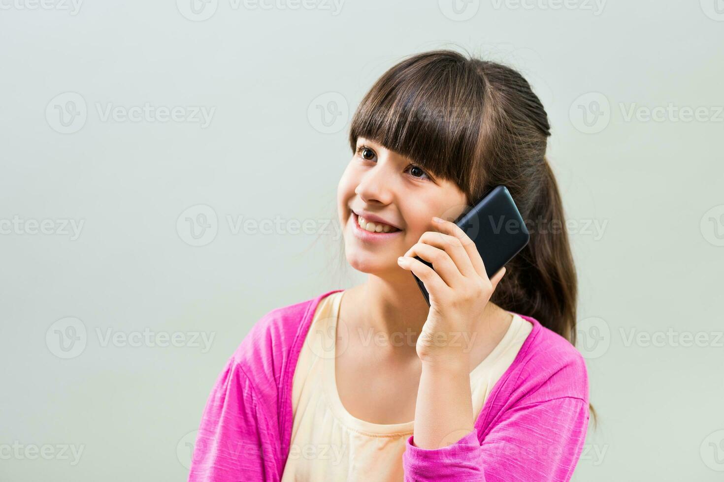 Little girl using mobile phone photo