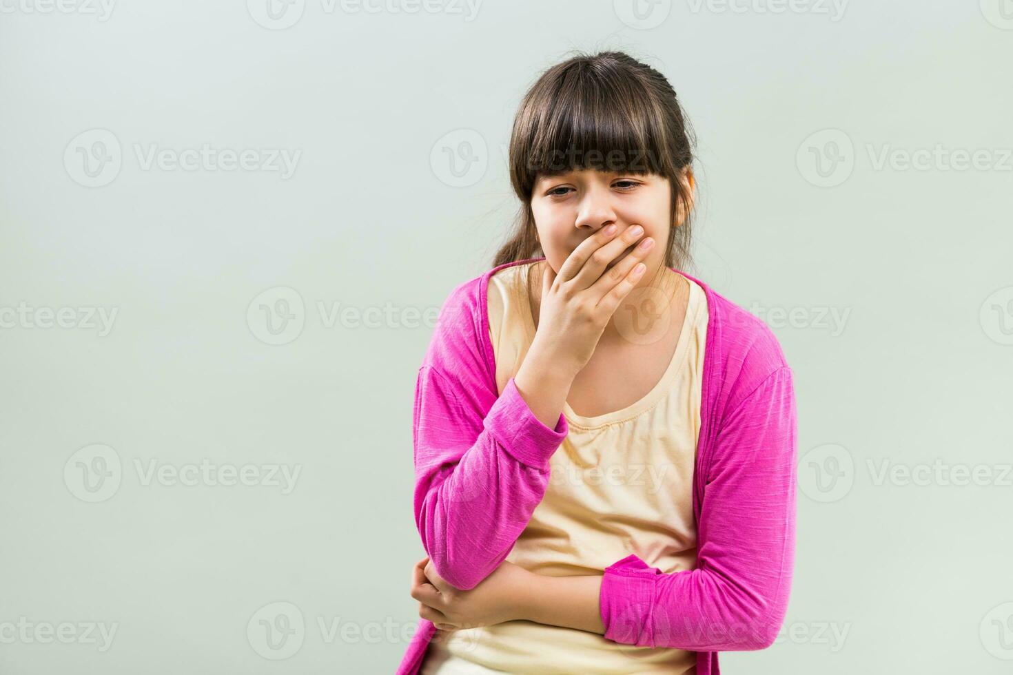 Little girl is having stomachache and she is going to vomit. photo