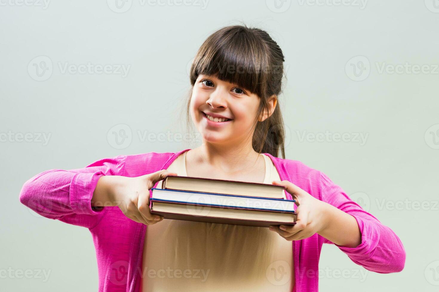 Little girl holding books photo