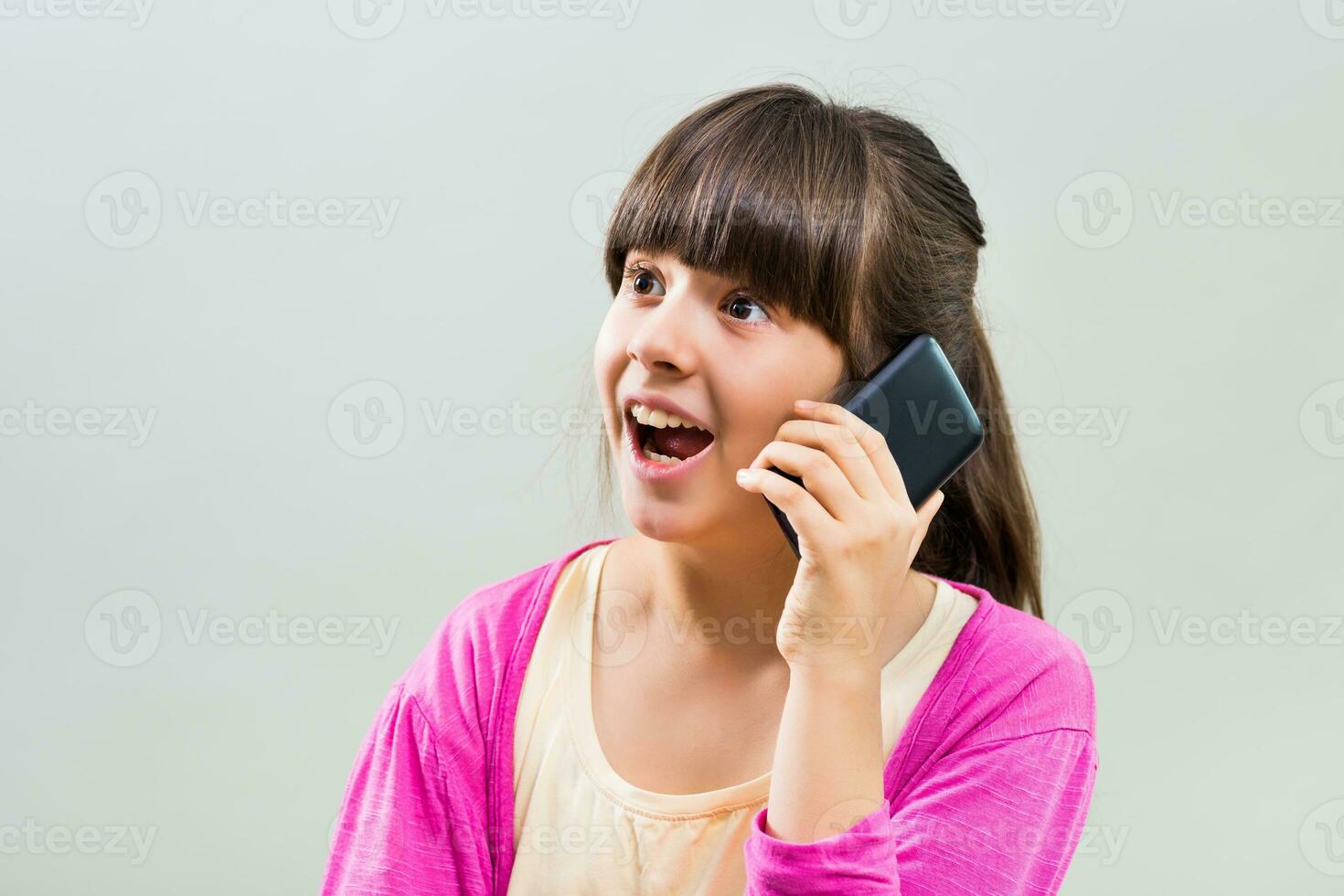 Little girl using mobile phone photo