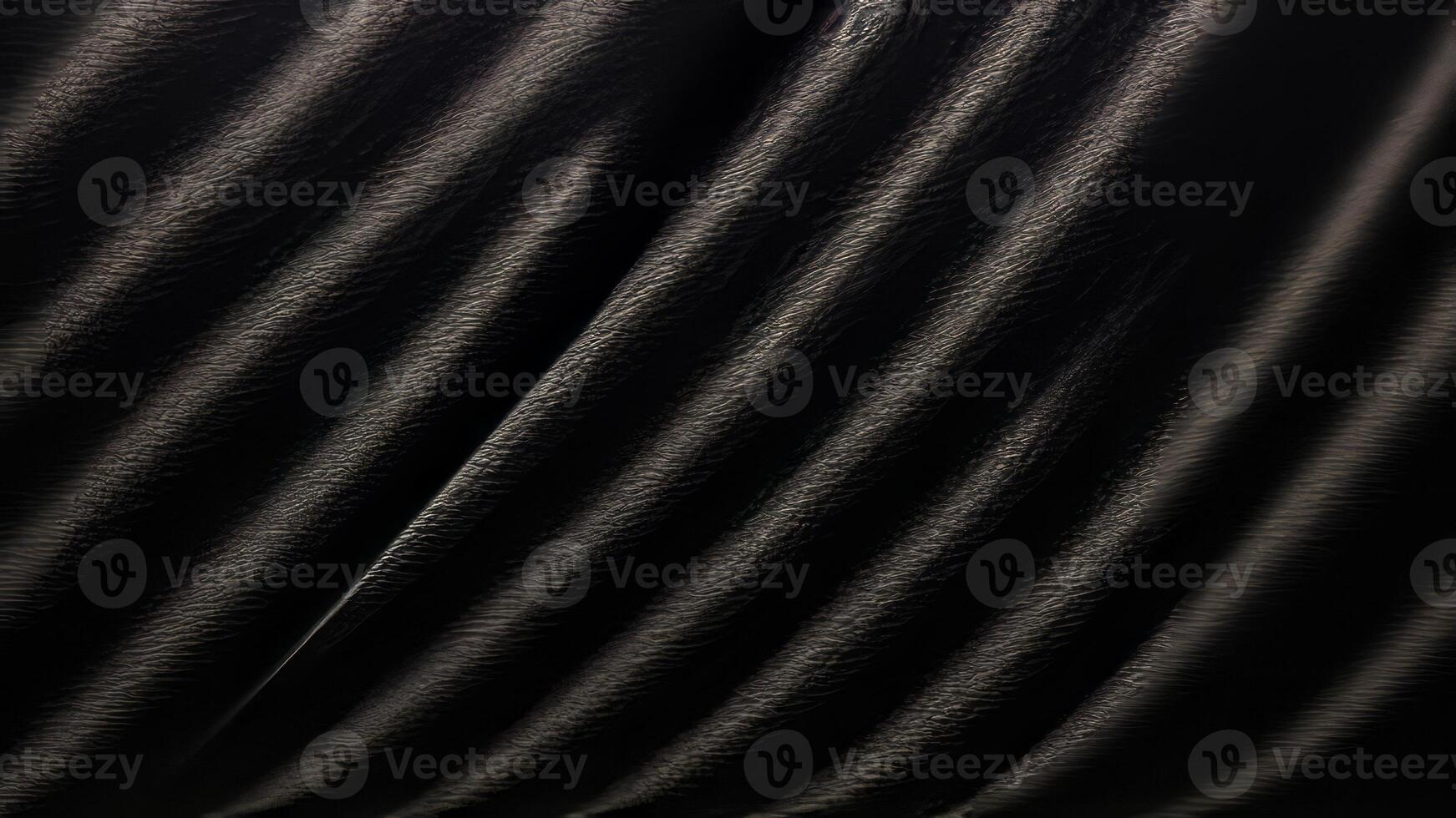 Heavy crumpled black paper texture in low light background. photo