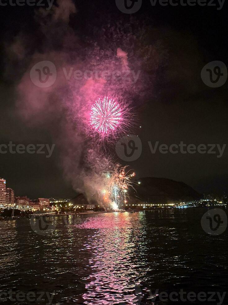 colorful fireworks in the night sky on the seafront of Alicante spain photo