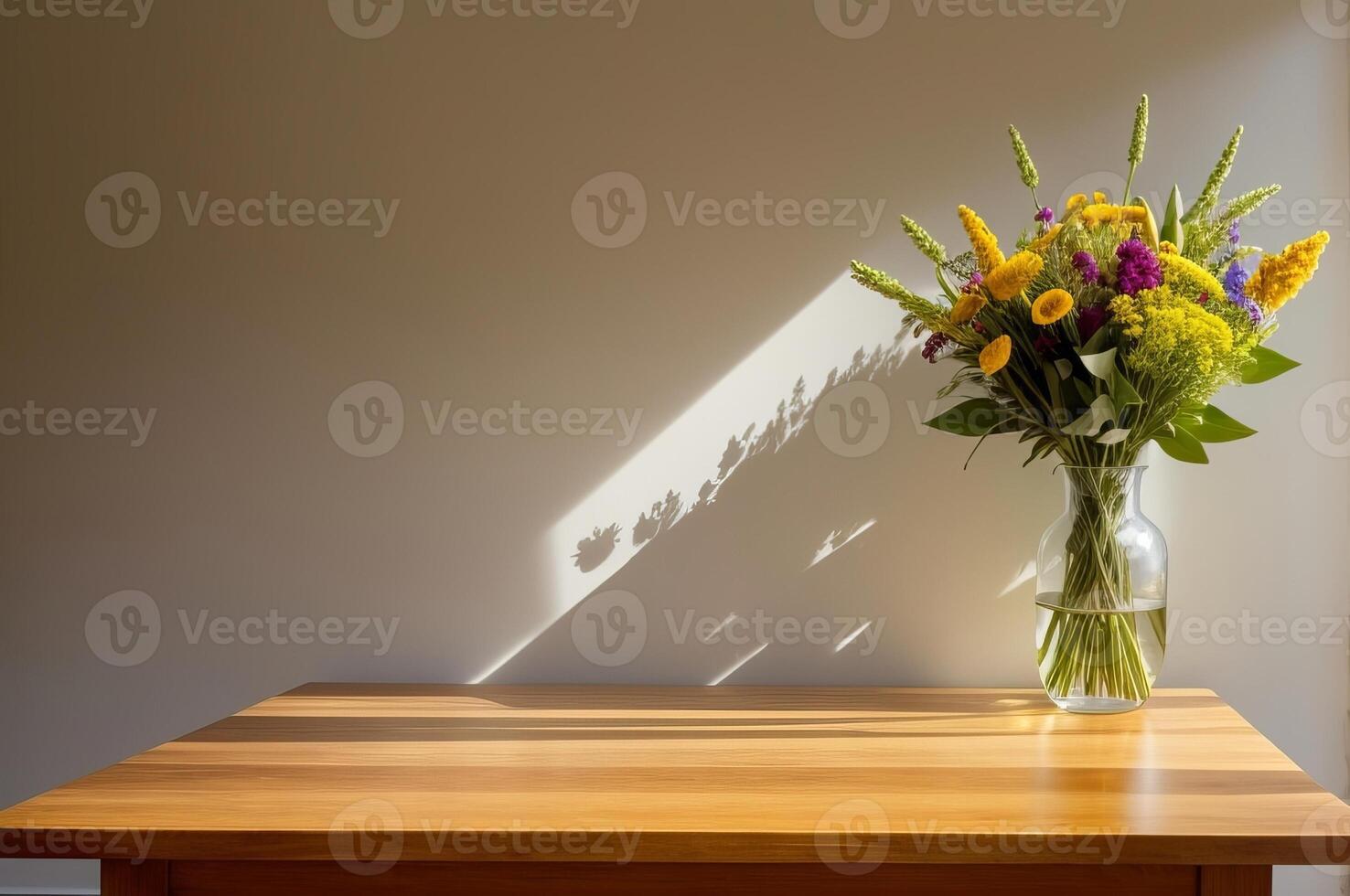 Wooden table with vase with bouquet of dried flowers near empty, blank wall. photo