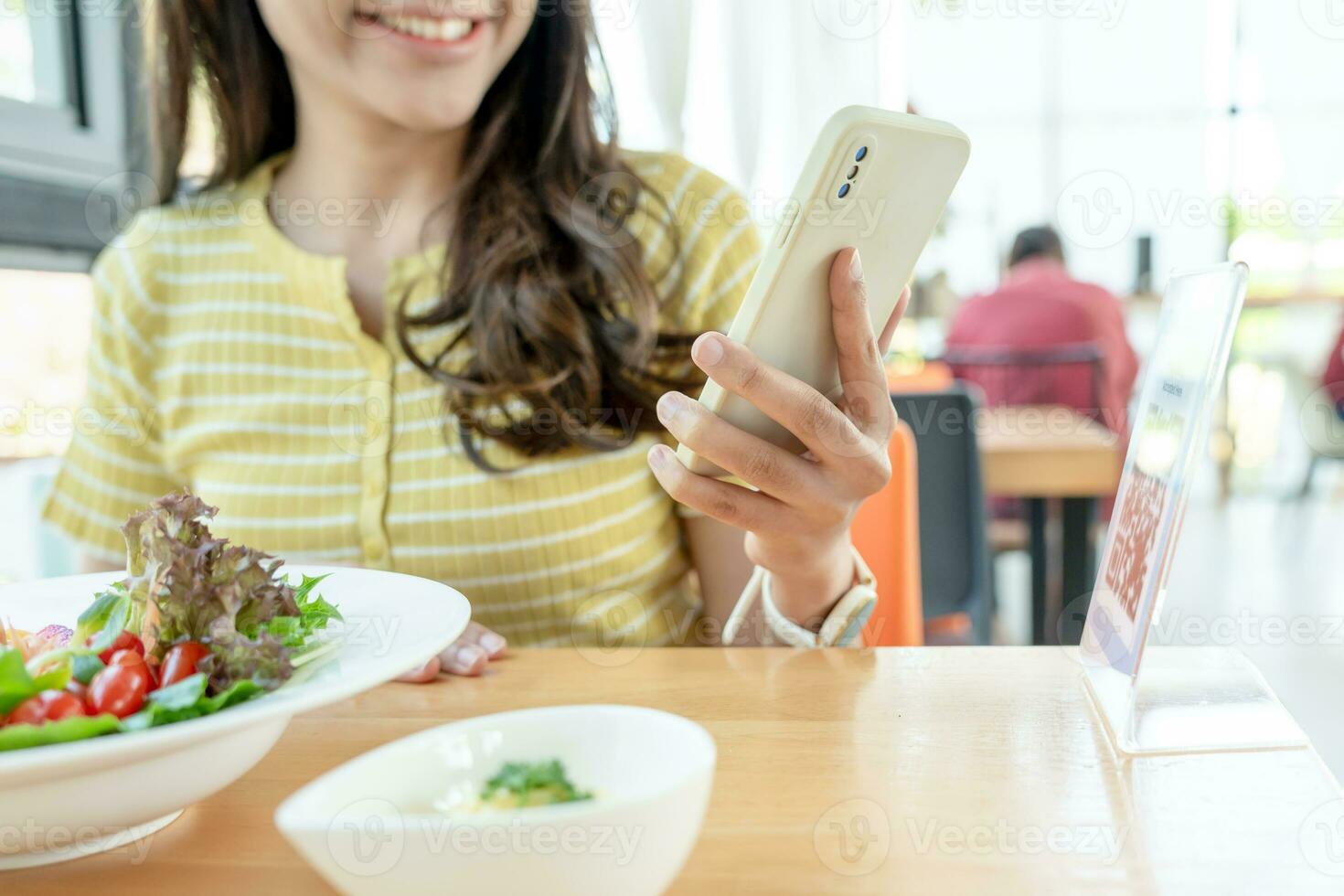Woman use smartphone to scan QR code to pay in cafe restaurant with a digital payment without cash. Choose menu and order accumulate discount. E wallet, technology, pay online, credit card, bank app. photo