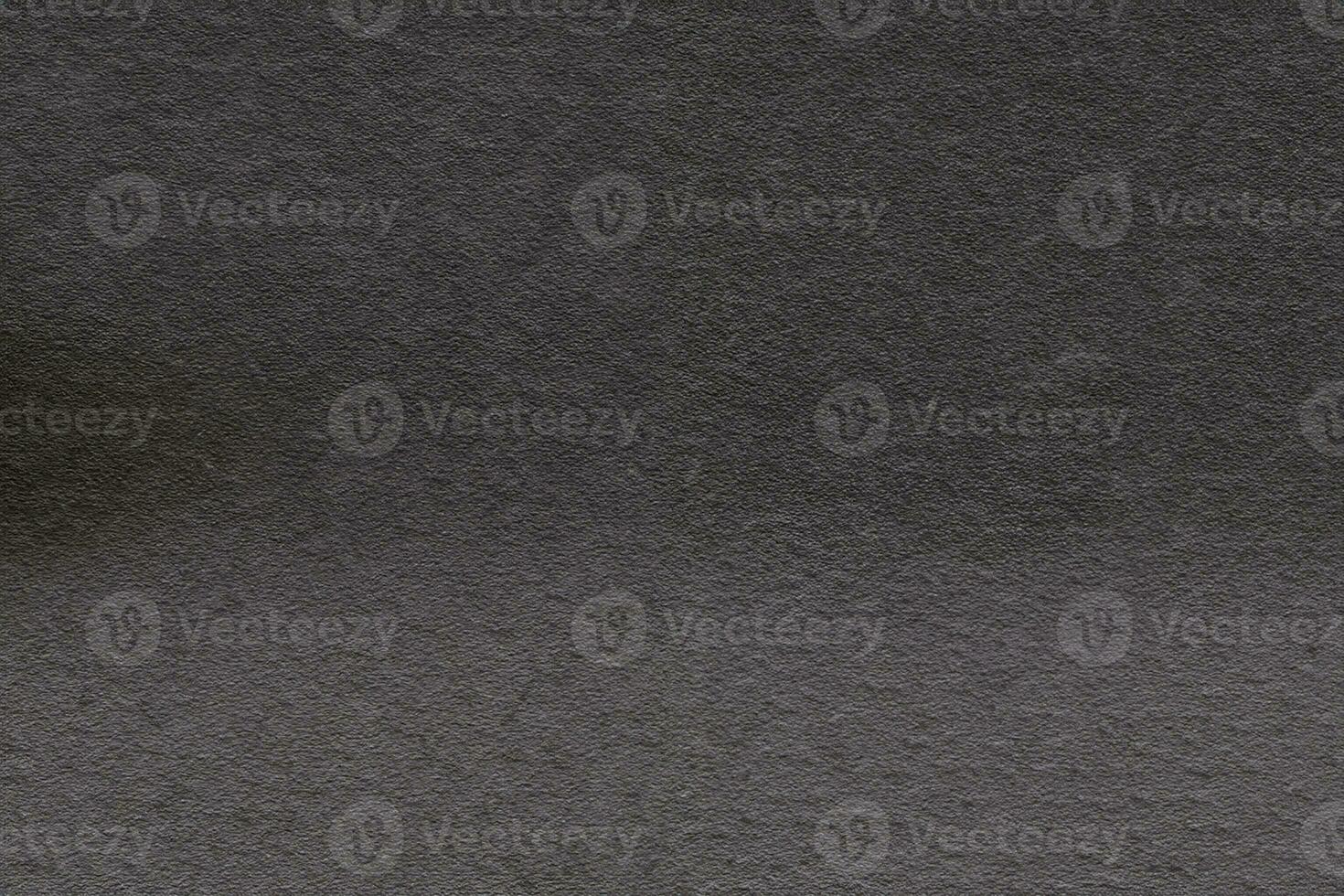 Dark gray background from natural slate. Texture of stone closeup. Graphite background macro photo