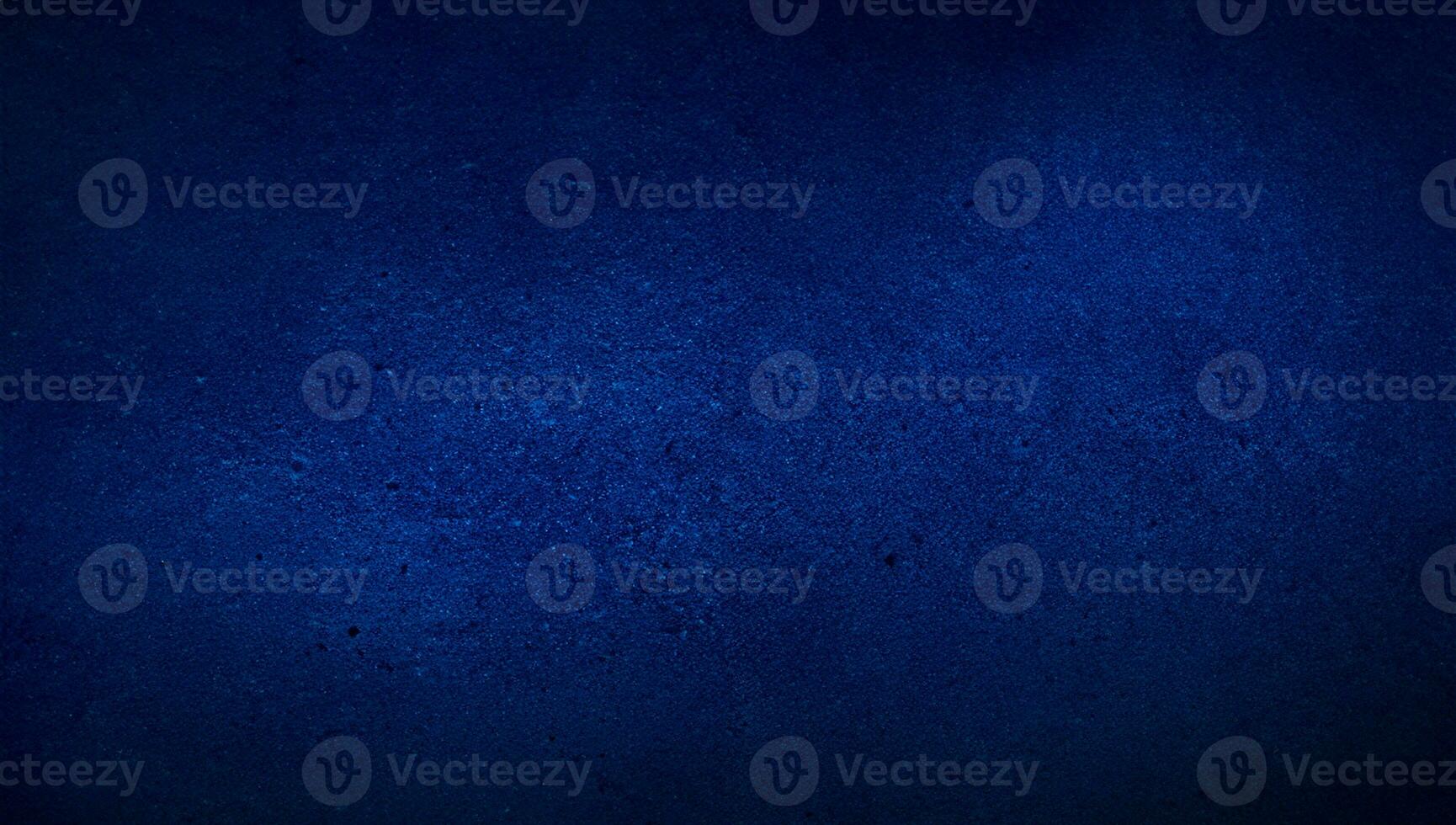 blank blue texture surface background with dark corners. blue grainy cement wall background with space for text. photo