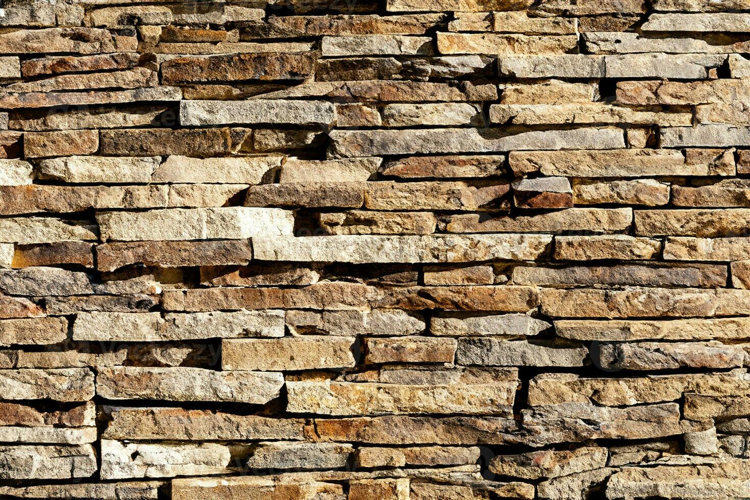Background of stone wall texture. The surface of the stones is brown photo