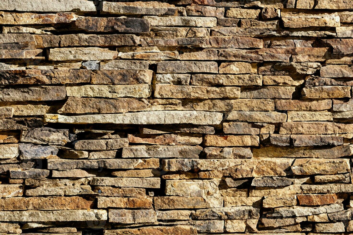 Background of stone wall texture. The surface of the stones is brown photo