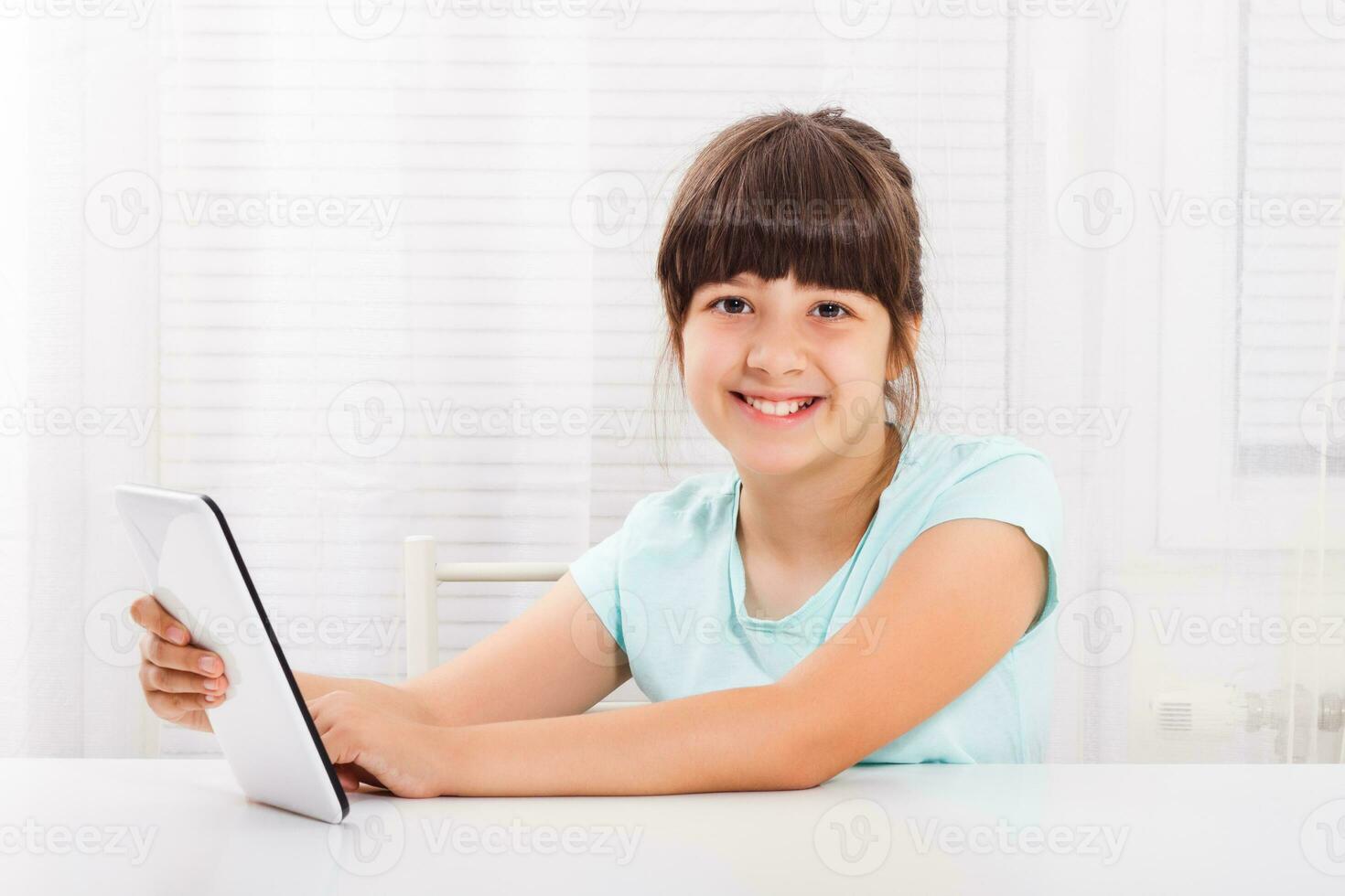 Little girl using digital tablet photo