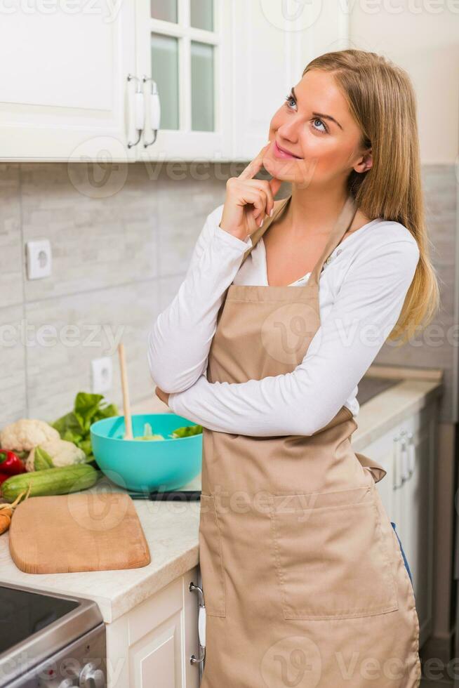 Beautiful woman thinking what to cook photo