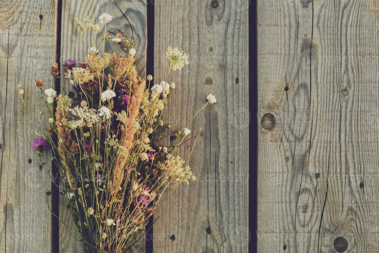 Beautiful bouquet of flowers on wooden table photo