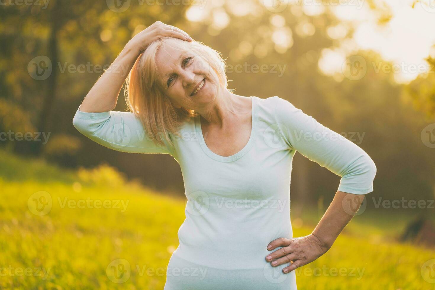 Sporty senior woman exercising outdoor photo