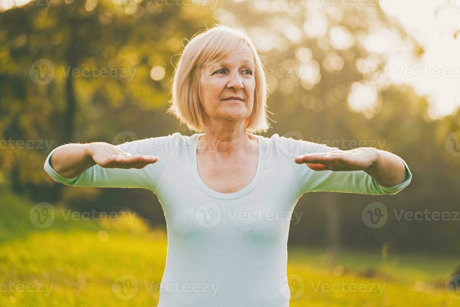 Sporty senior woman exercising outdoor photo