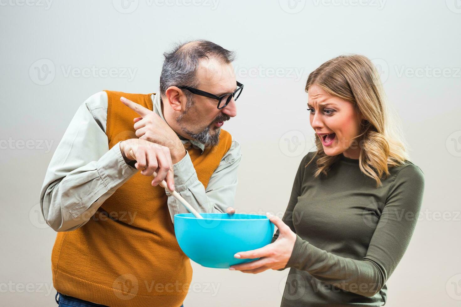 Nerdy man would like that his wife spend more time in the kitchen,but she doesn't want to. photo