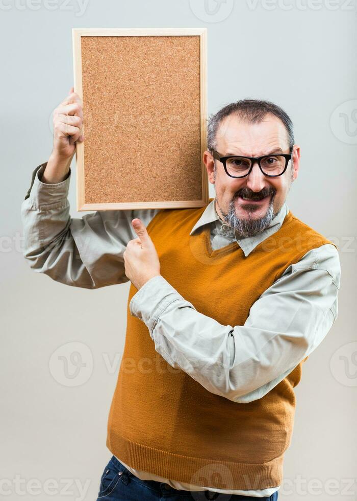 Nerdy businessman is showing empty cork board photo