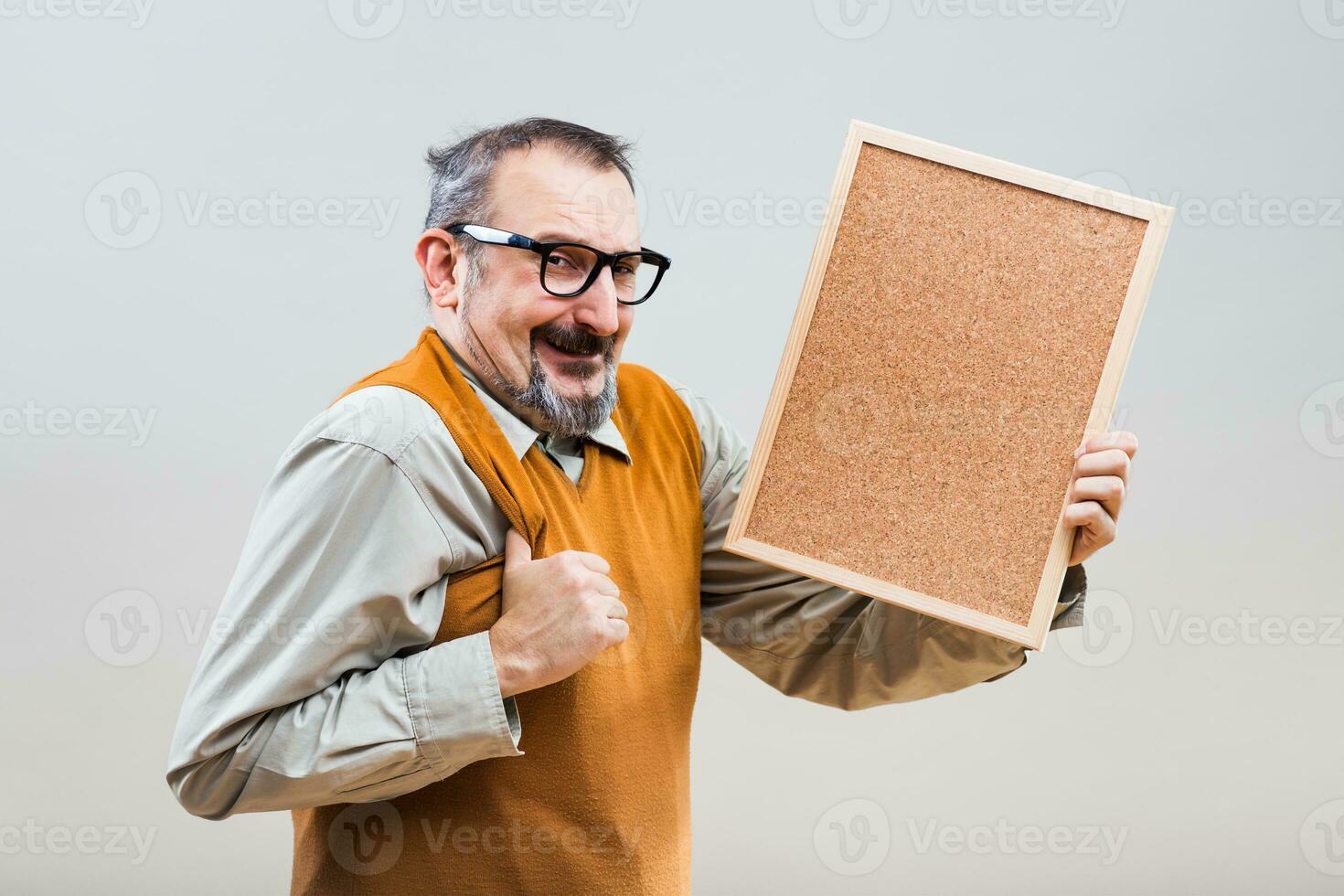 Nerdy businessman is showing empty cork board photo