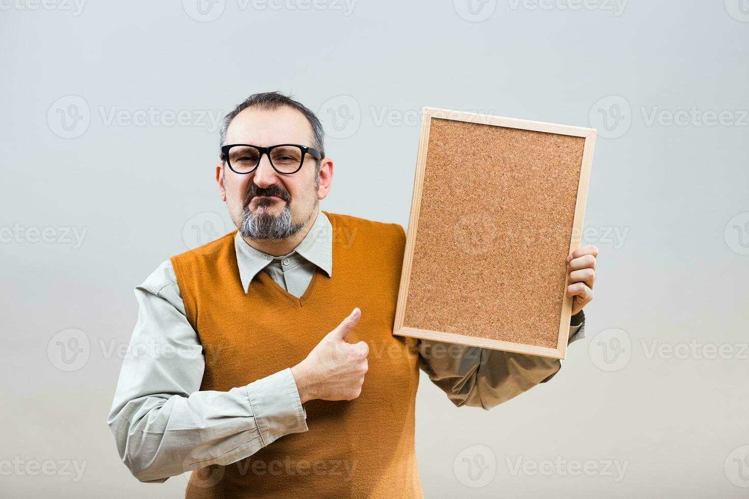 Nerdy businessman is showing empty cork board photo