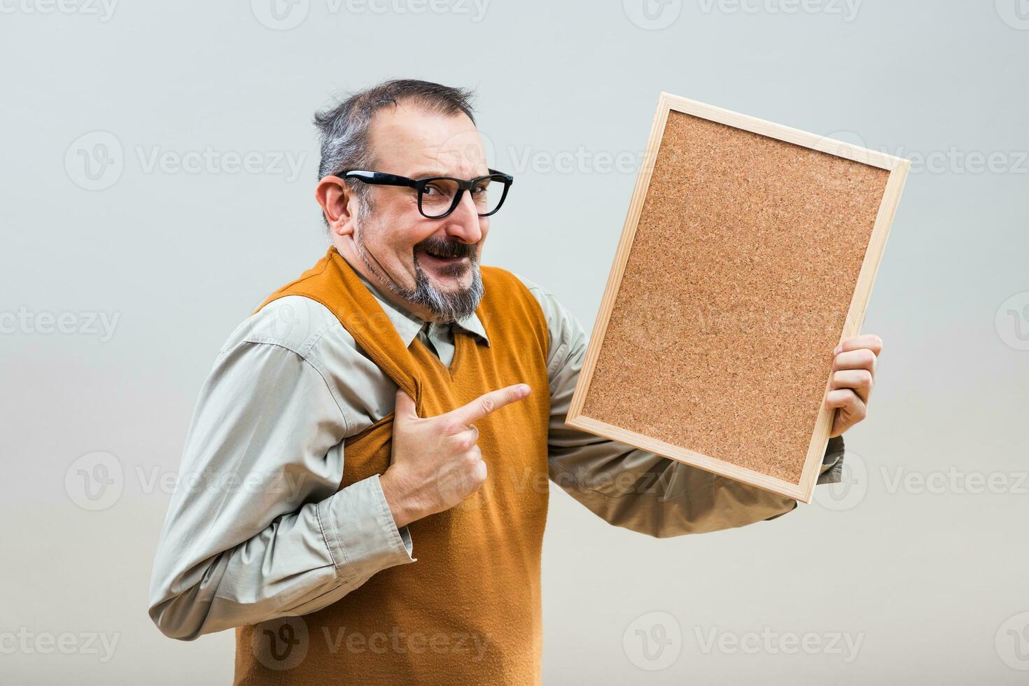 Nerdy businessman is showing empty cork board photo