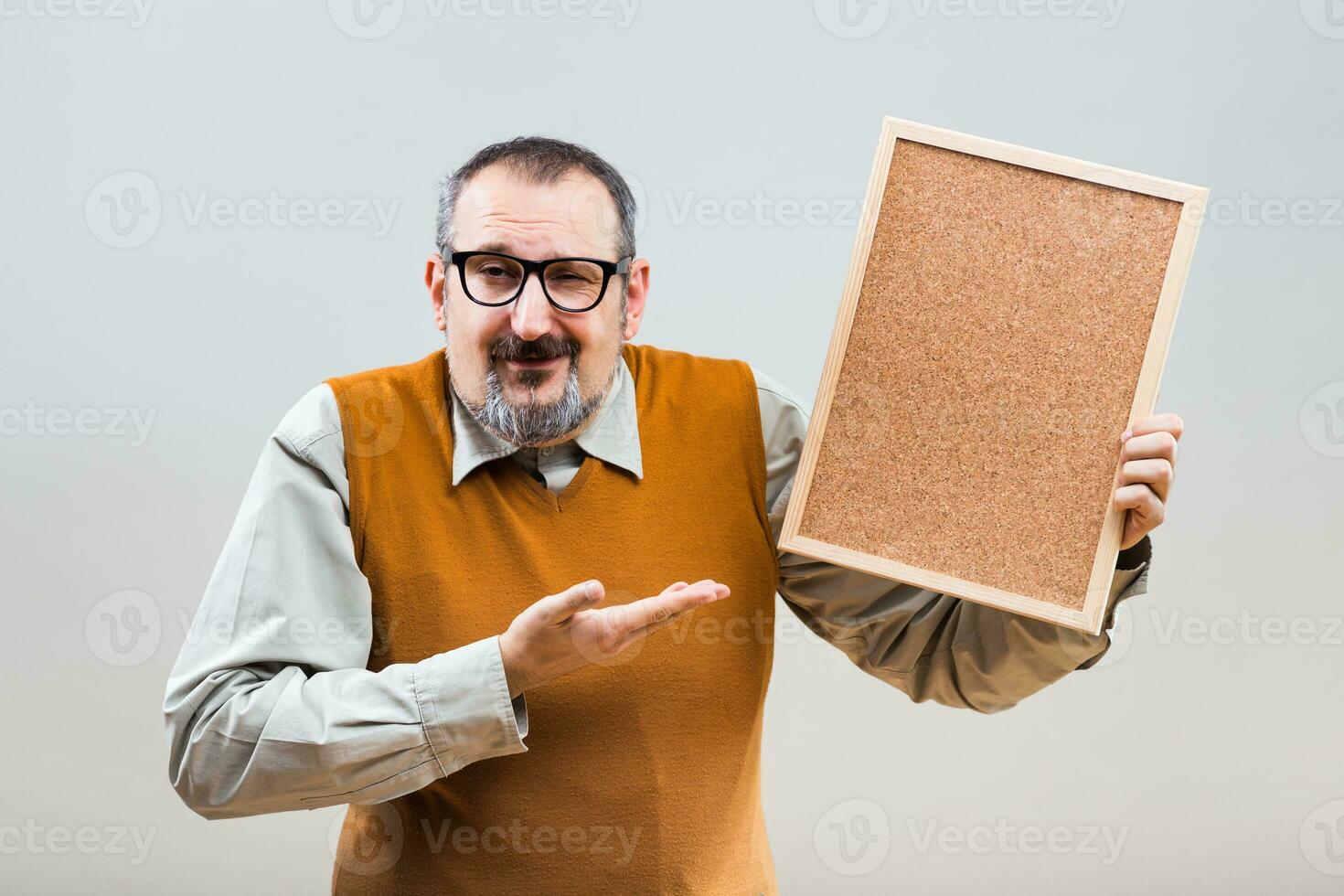 Nerdy businessman is showing empty cork board photo