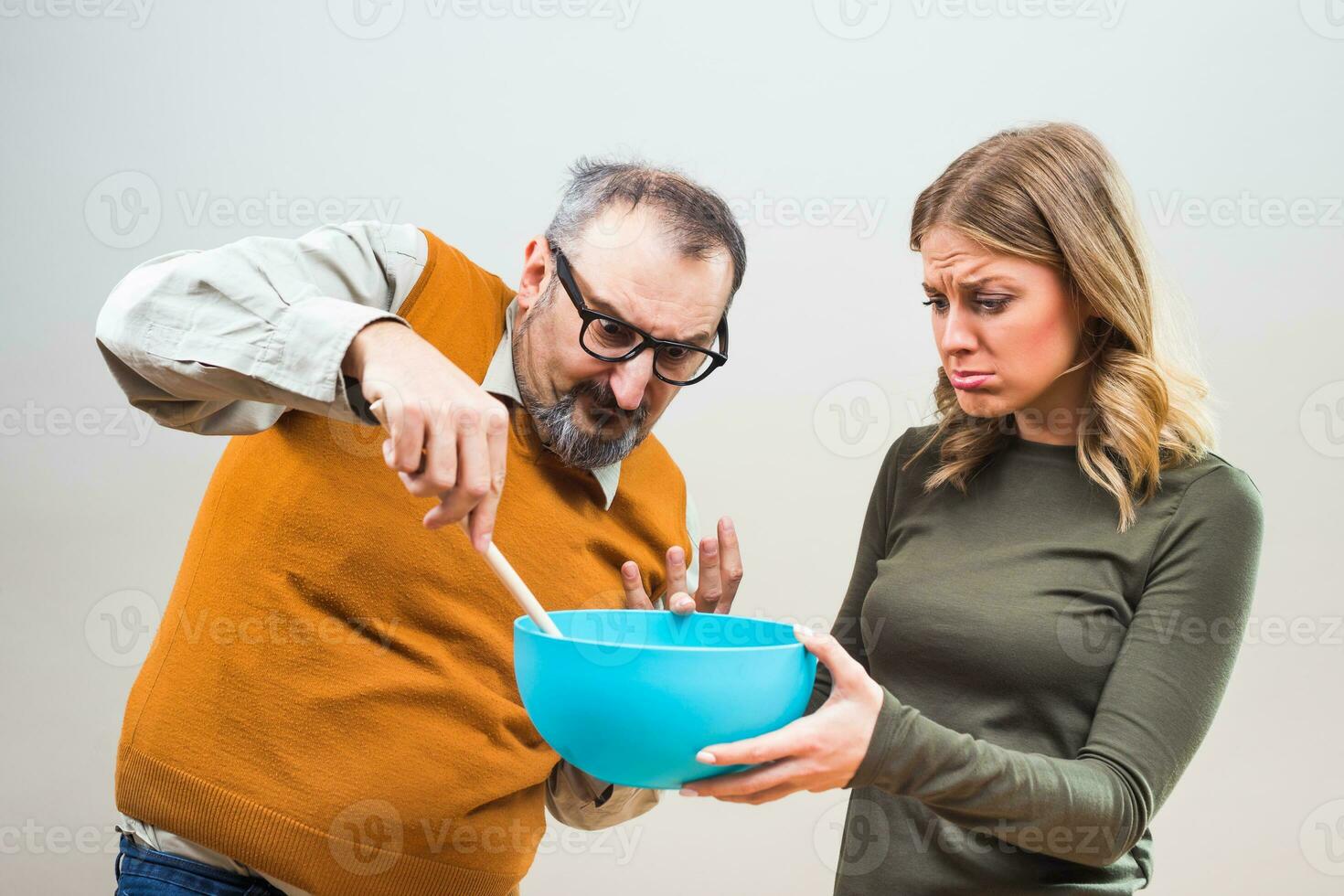 Nerdy man would like that his wife spend more time in the kitchen,but she doesn't want to. photo