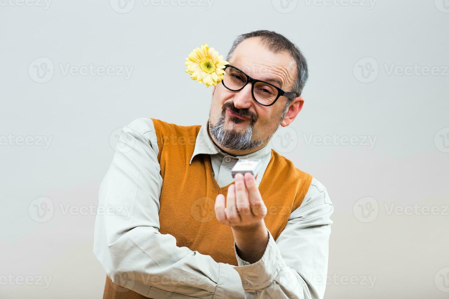 Self confident nerdy man is proposing his girlfriend photo