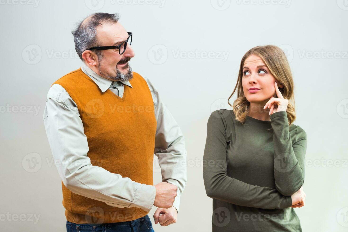 Nerdy man is trying to get beautiful woman's attention but she is not interested and angry ignore him photo