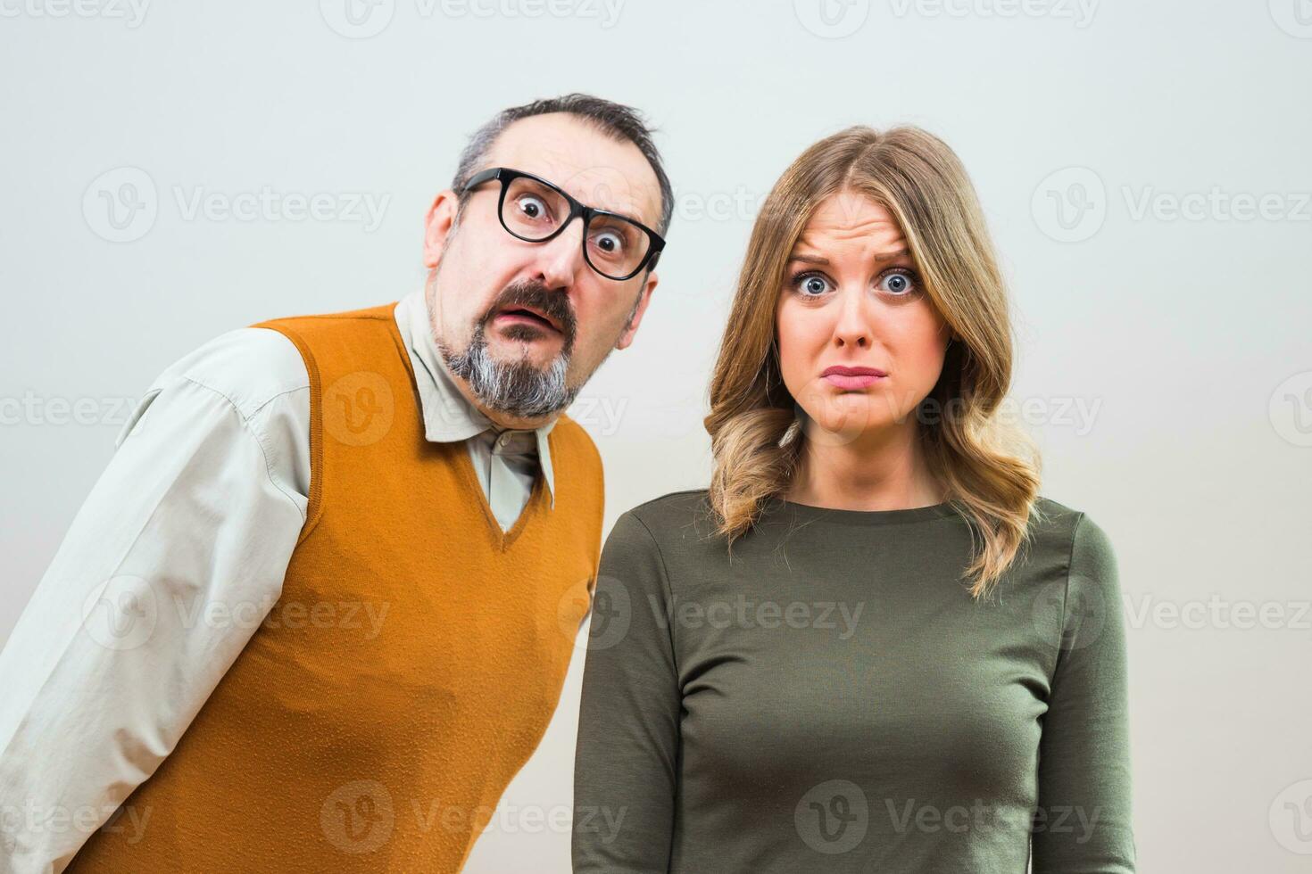 Nerdy man is trying to get beautiful woman's attention but she is not interested and desperately thinking the way to escape photo