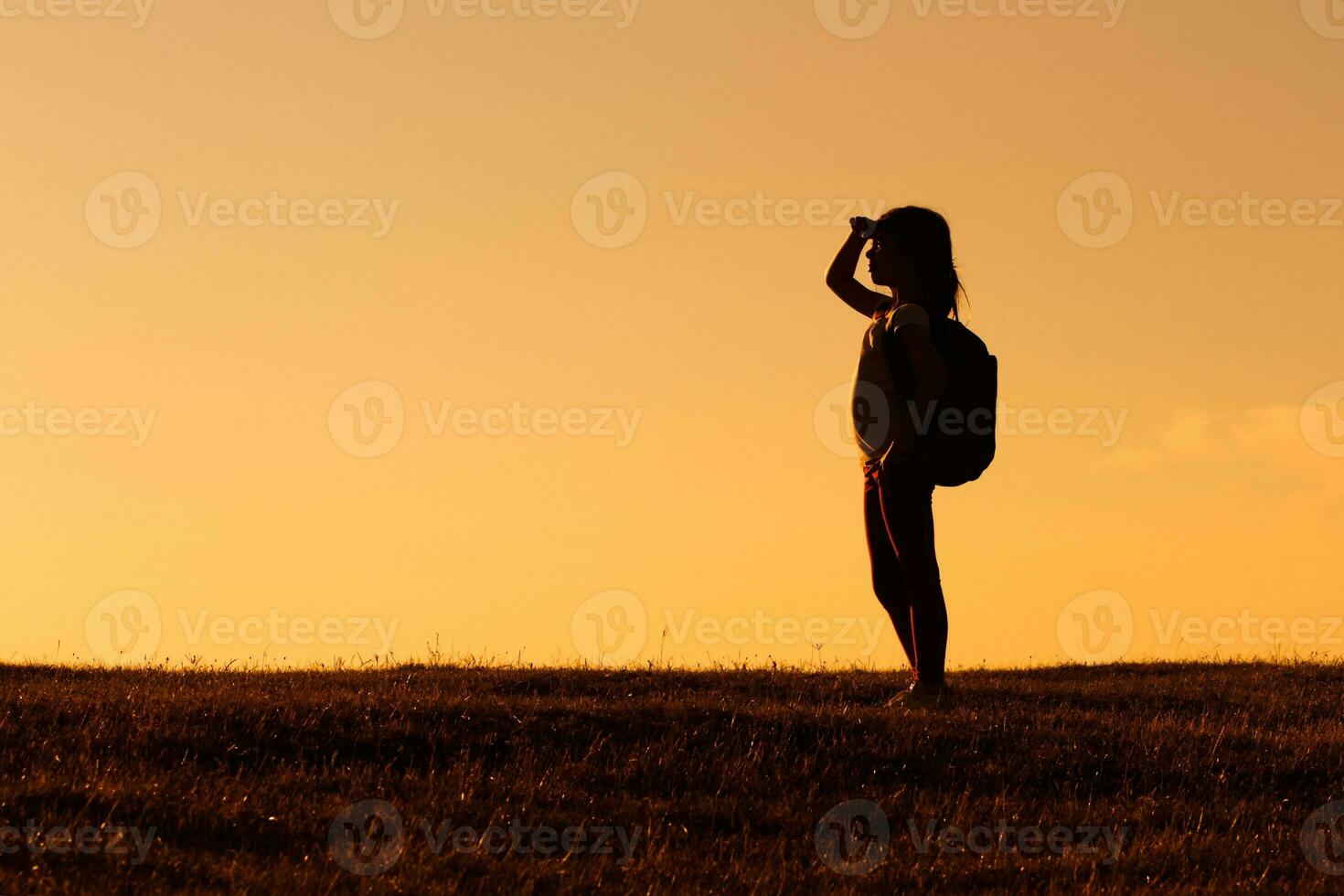 Little girl hiker looking at view photo