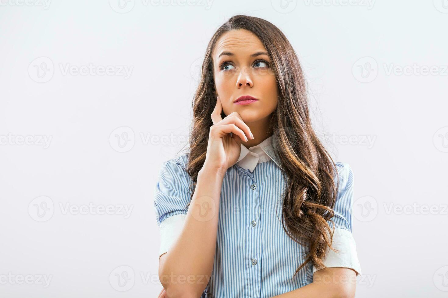 Worried businesswoman thinking on gray background photo