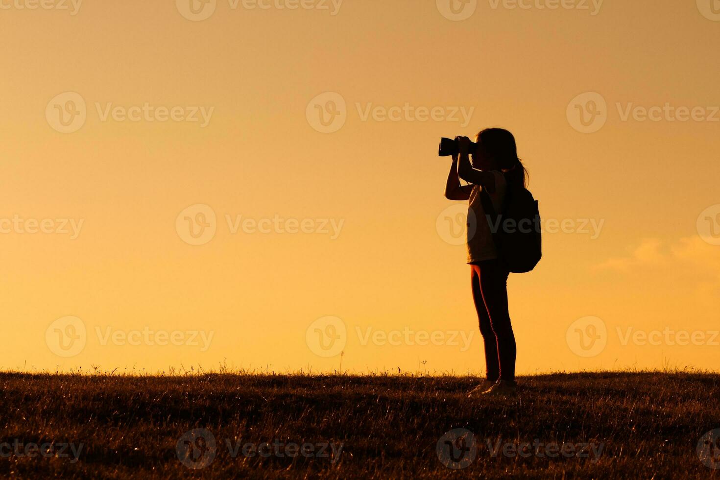 Little girl hiker with binoculars photo