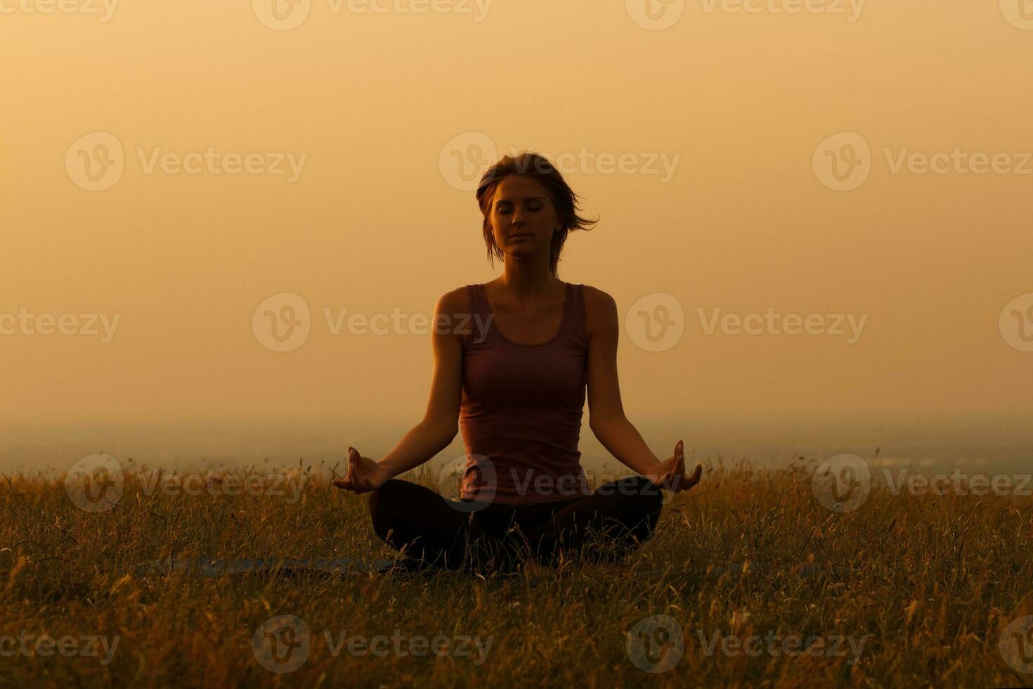 Woman meditating in the nature photo