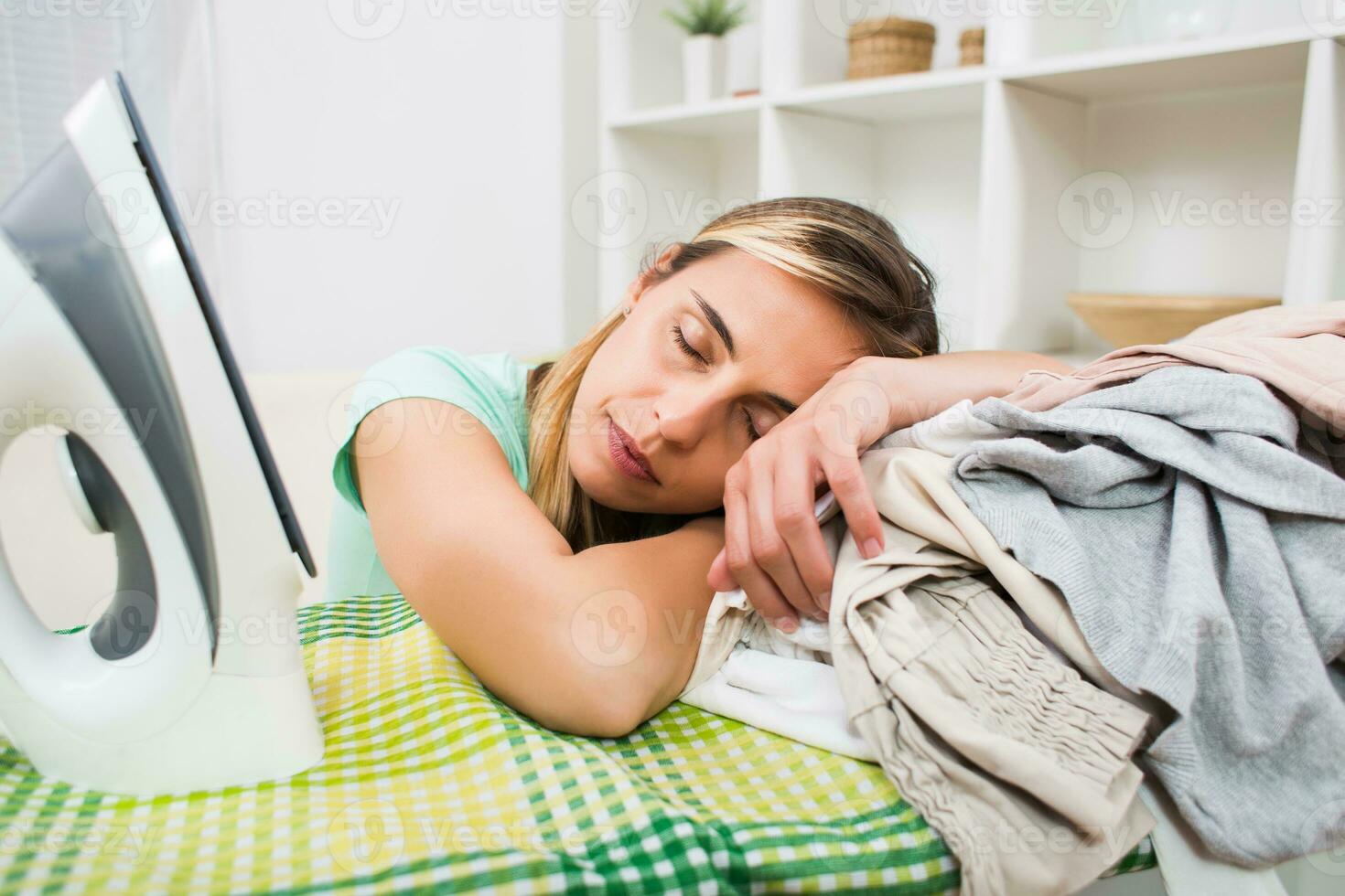 Beautiful woman is tired of ironing every day photo
