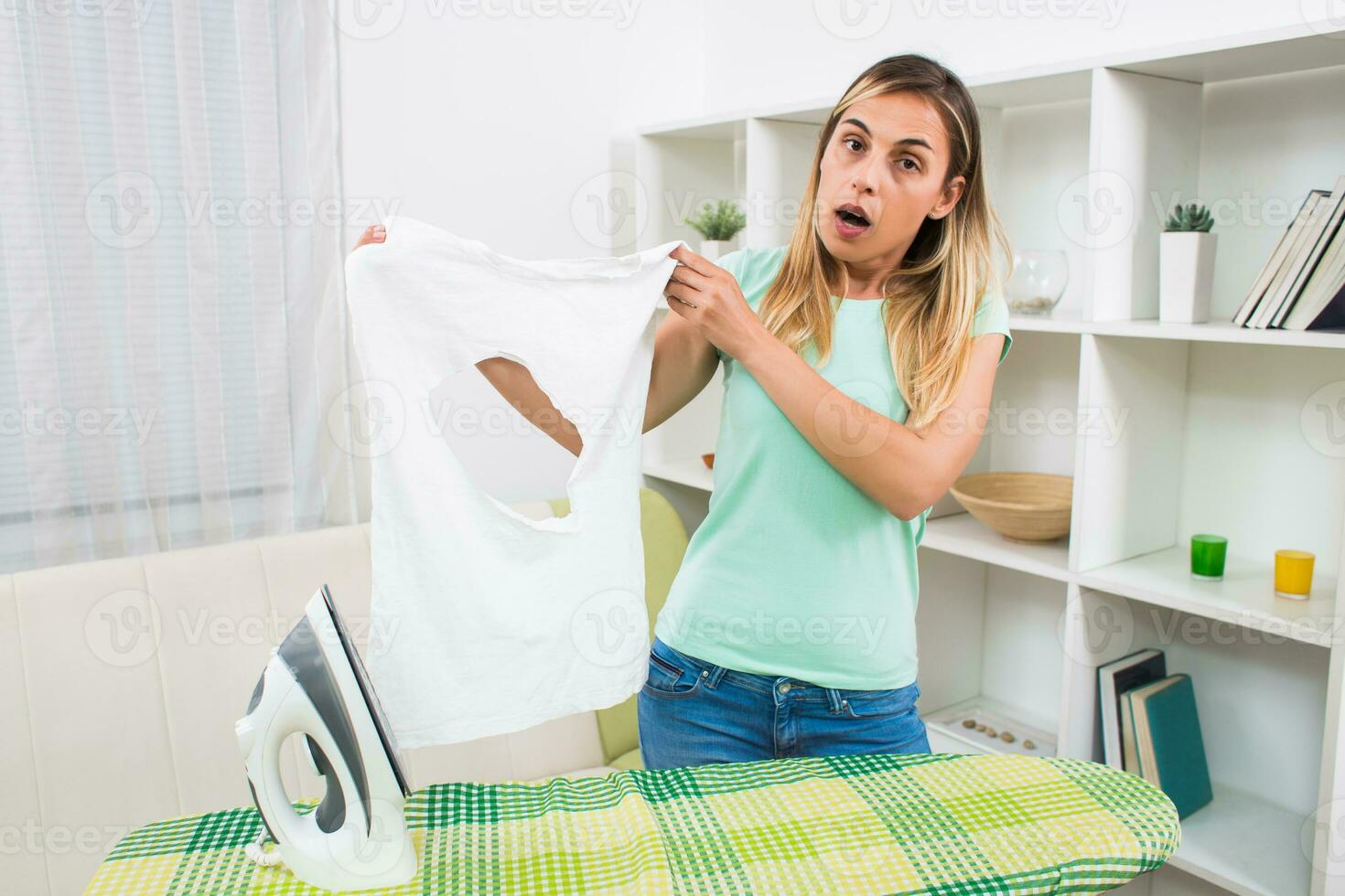 Desperate woman made a hole on her t-shirt and damaged her iron photo