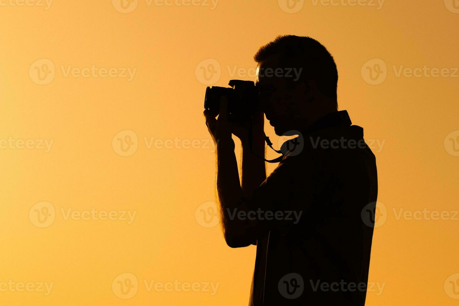 Silhouette of a man photographing photo