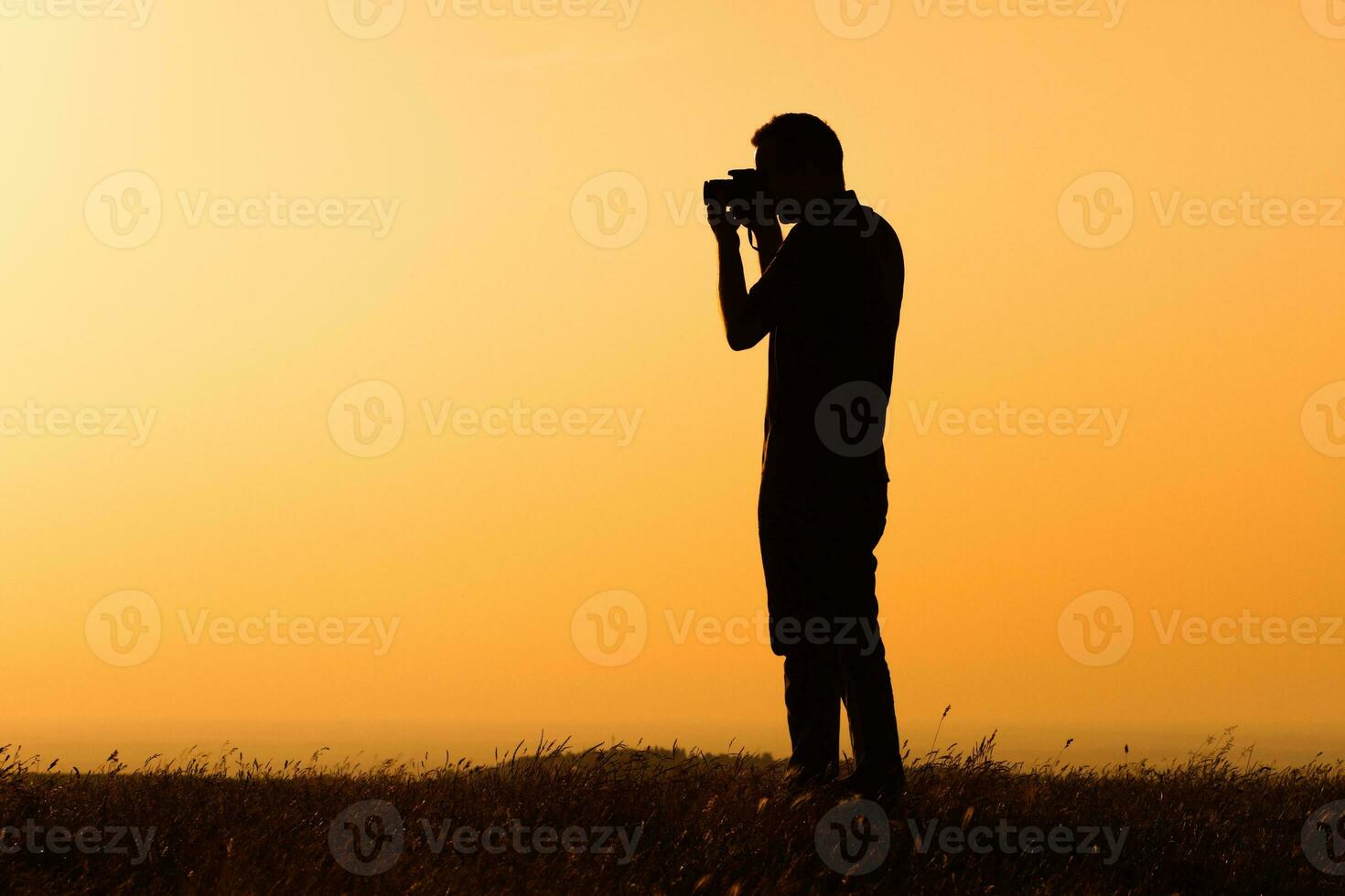 Silhouette of a man photographing photo