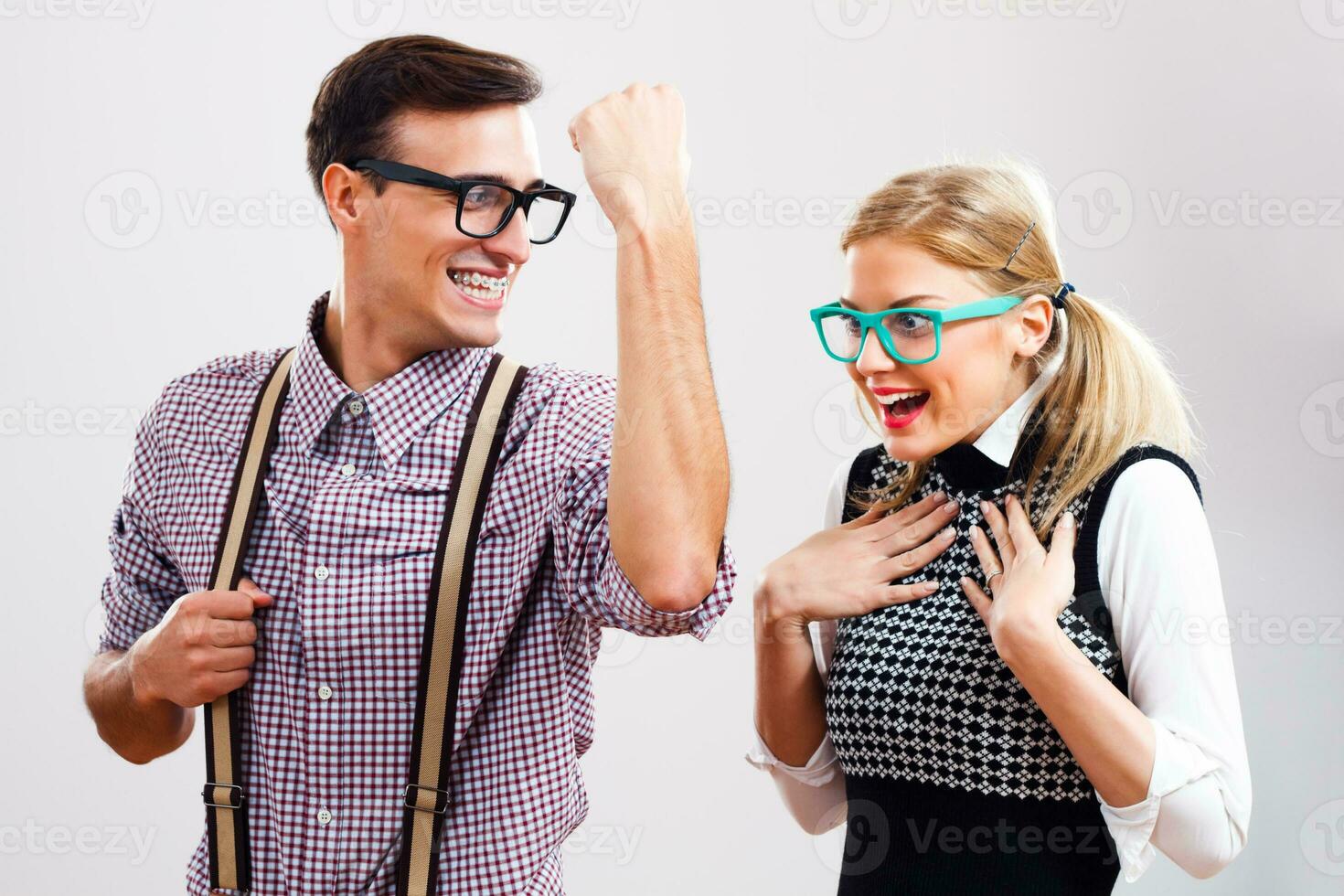 Nerdy man is showing to nerdy girl how strong he is photo