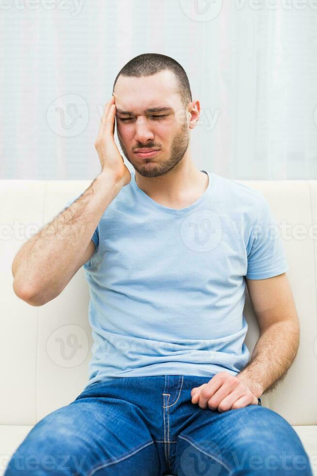 Young man is having headache photo
