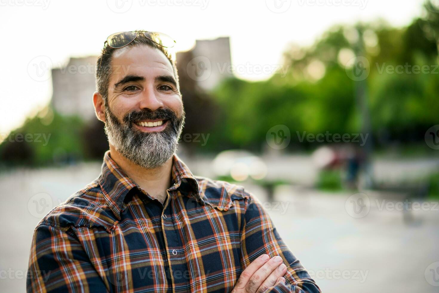 retrato de moderno empresario con barba en pie en el ciudad calle foto