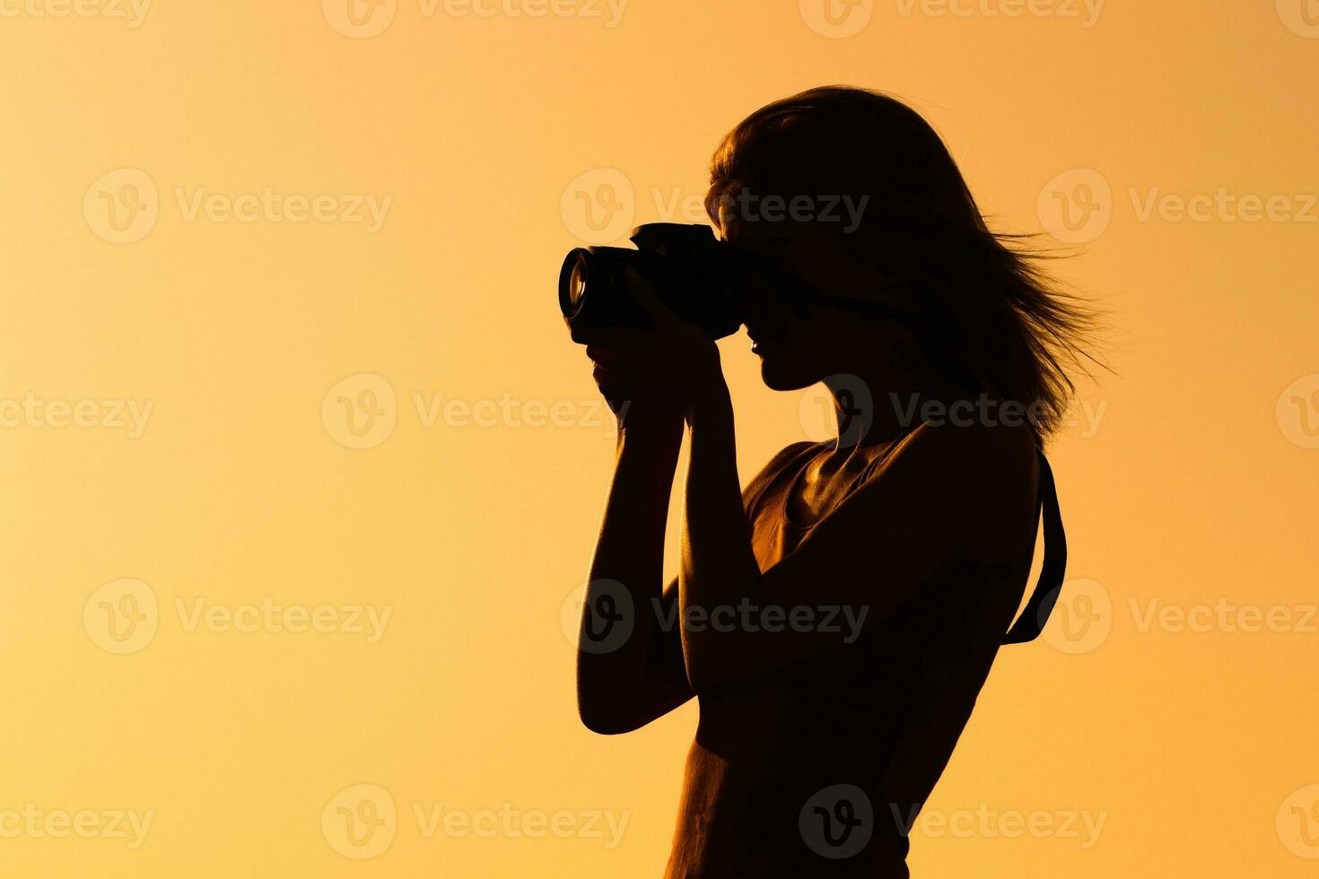 Silhouette of a woman photographing photo