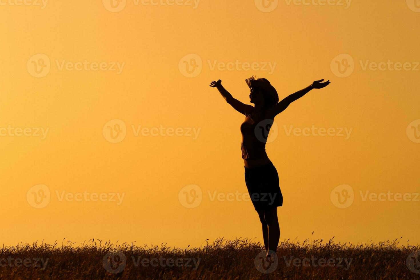 Silhouette of a  woman with her arms  outstretched photo