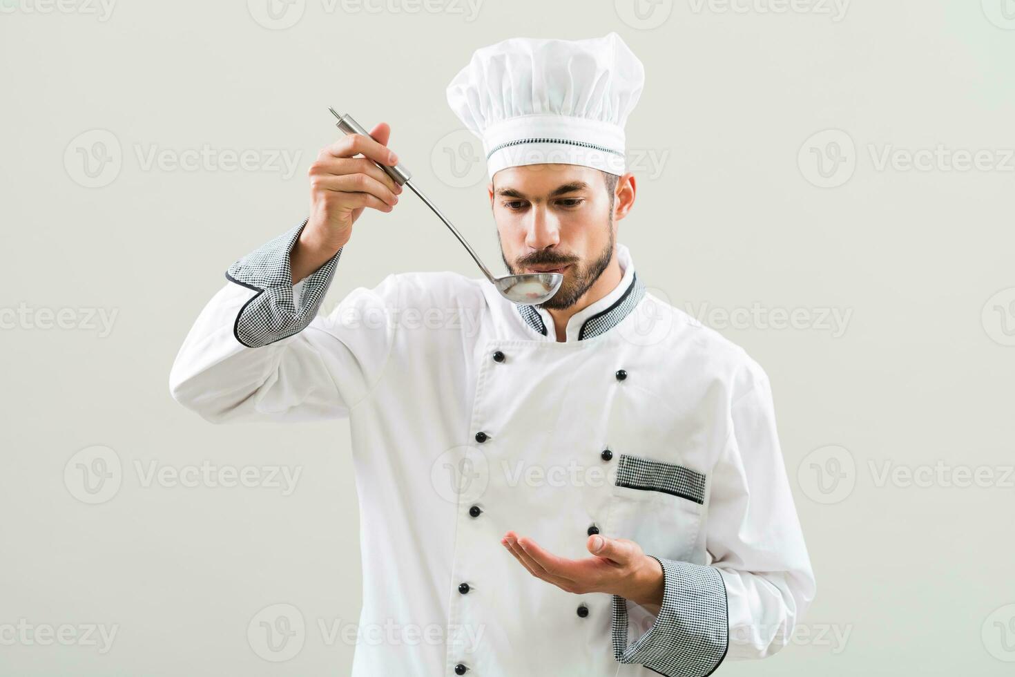 Chef is tasting meal that he has made. photo