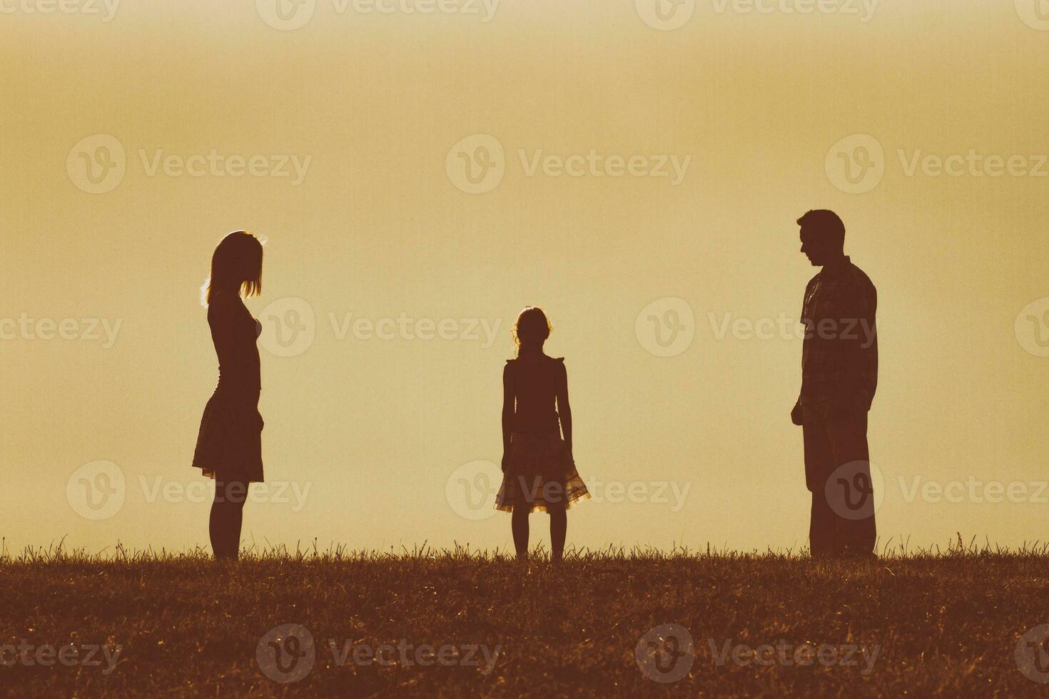 Silhouette of a angry husband and wife on each other looking at their daughter and waiting for her to choose between them photo