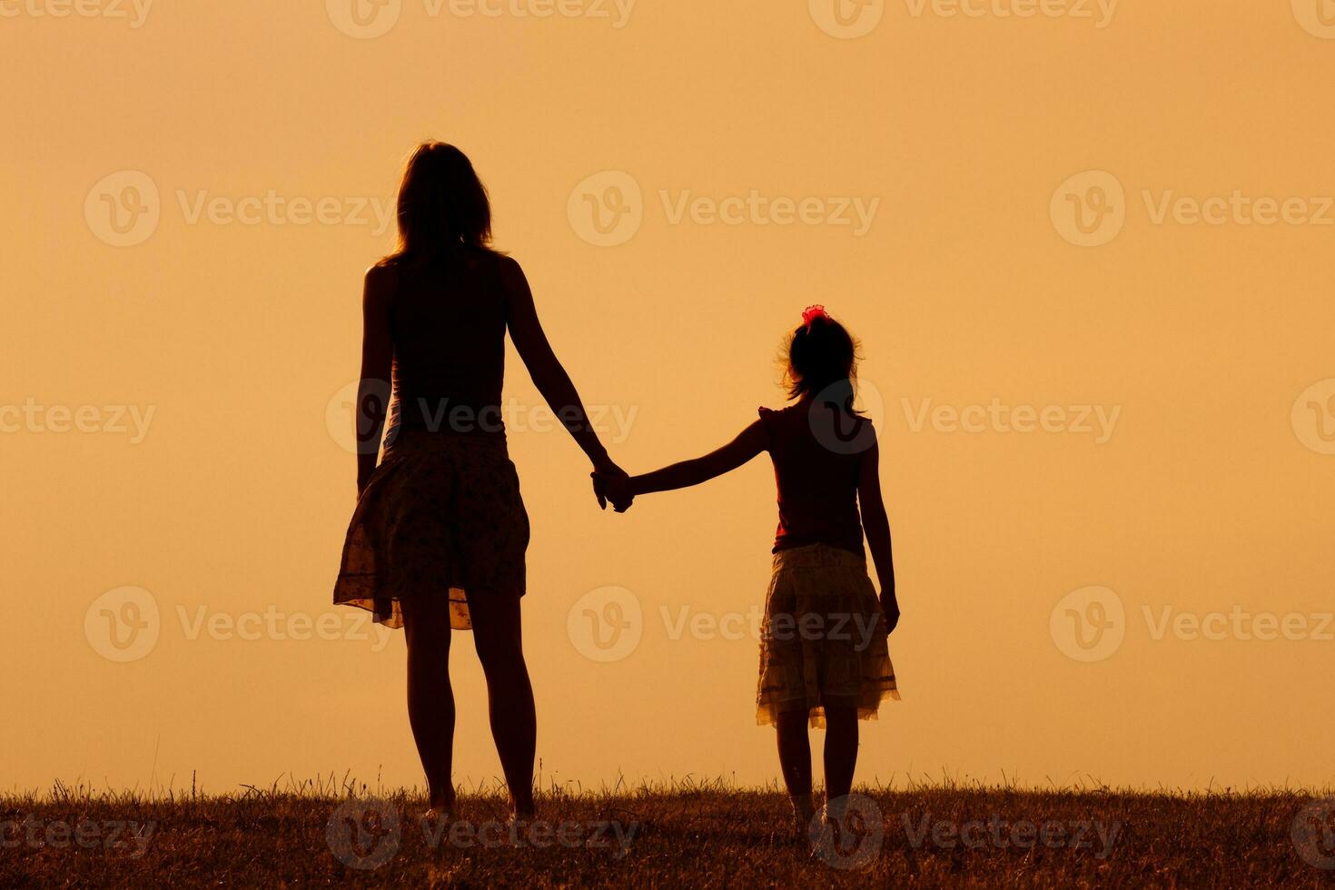 Mother and daughter enjoy watching sunset together photo