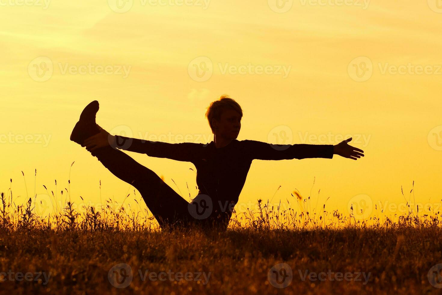 Silhouette of woman doing yoga photo