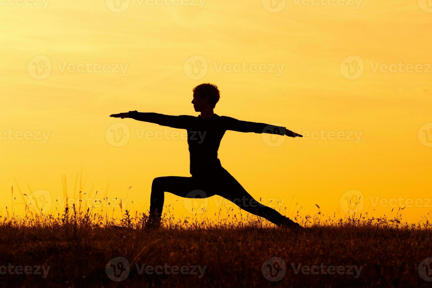 Silhouette of woman doing yoga photo