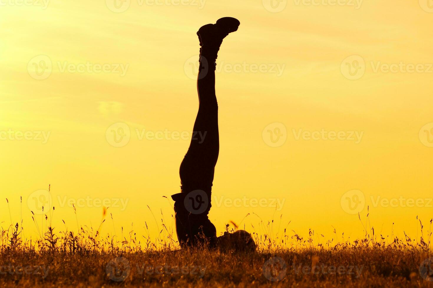 Silhouette of woman doing yoga photo