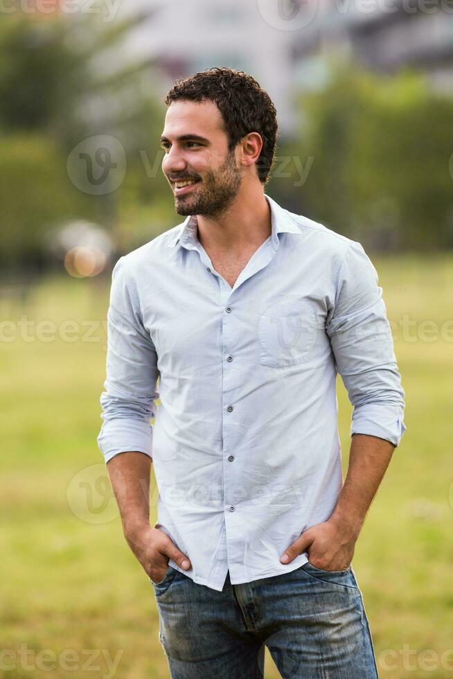 Young businessman is standing in the park photo